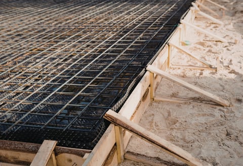 Rebar grid lining for a foundational concrete pour